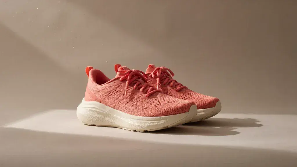 Official Ideogram sample of coral knit shoes on a warm neutral background