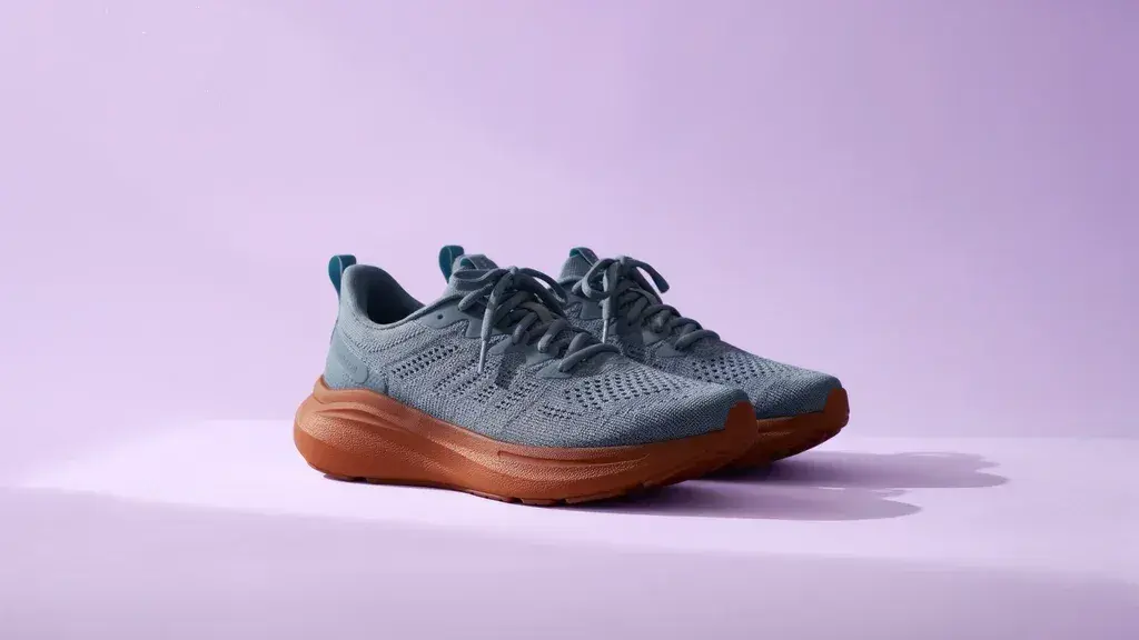Official third edit with slate-blue shoes, a gum sole, and a lilac background